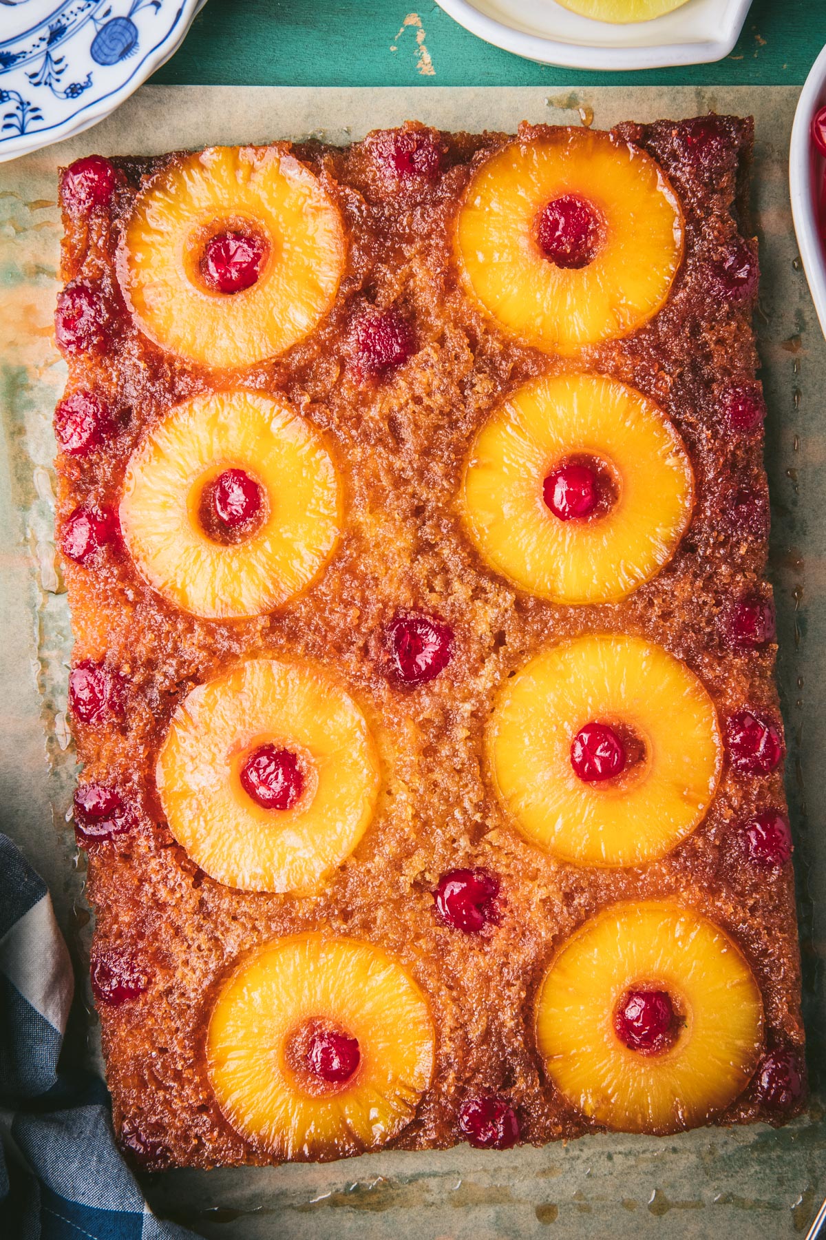 Pineapple upside down cake on a table before slicing