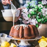 Drizzling glaze over grandmas lemon pound cake recipe.
