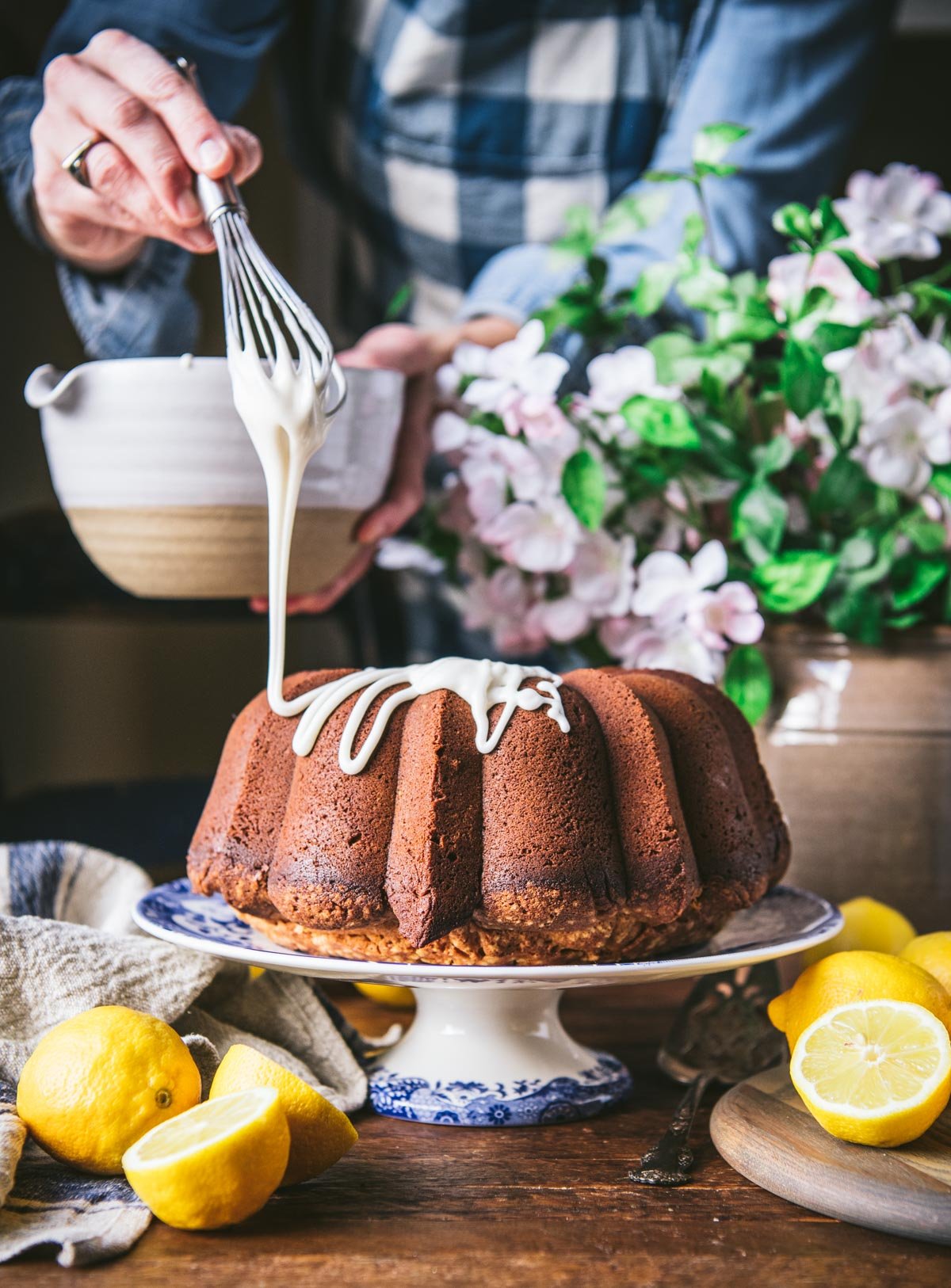 Drizzling glaze over grandmas lemon pound cake recipe.