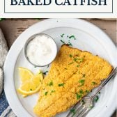 Overhead shot of a plate of baked catfish with text title box at top.