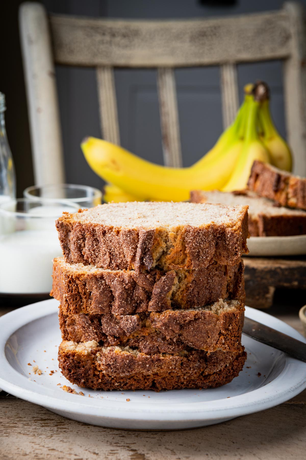 Front shot of a stack of buttermilk banana bread slices on a white plate