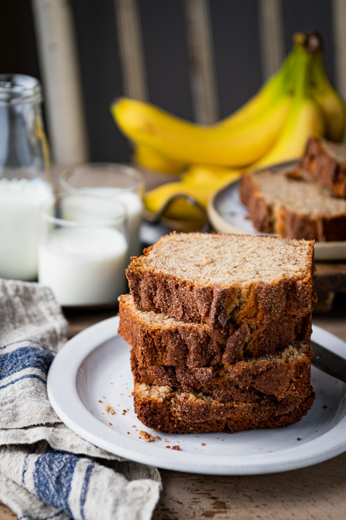 Stack of buttermilk banana bread slices on a white plate