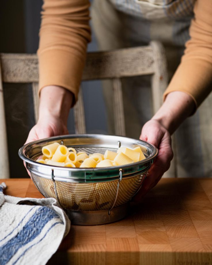 Cooked rigatoni in a colander.