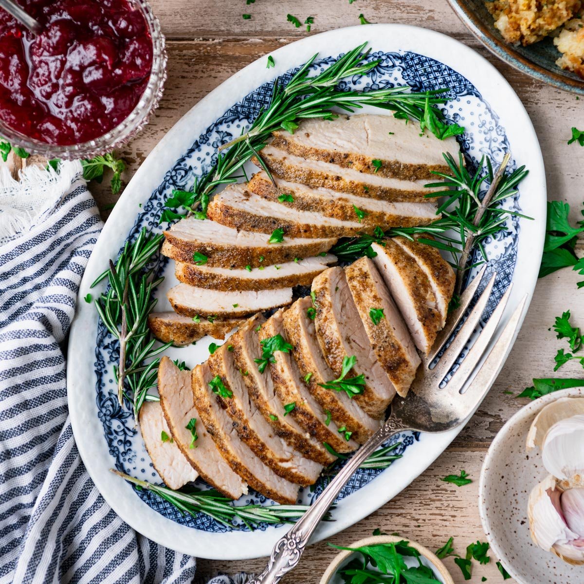 Square overhead image of a plate of sliced crock pot turkey tenderloin