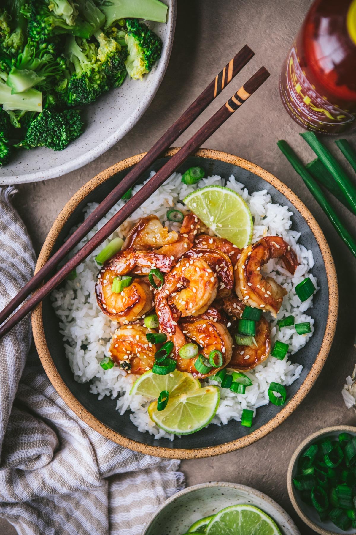 Overhead shot of a bowl of honey sriracha shrimp with a side of broccoli and rice.