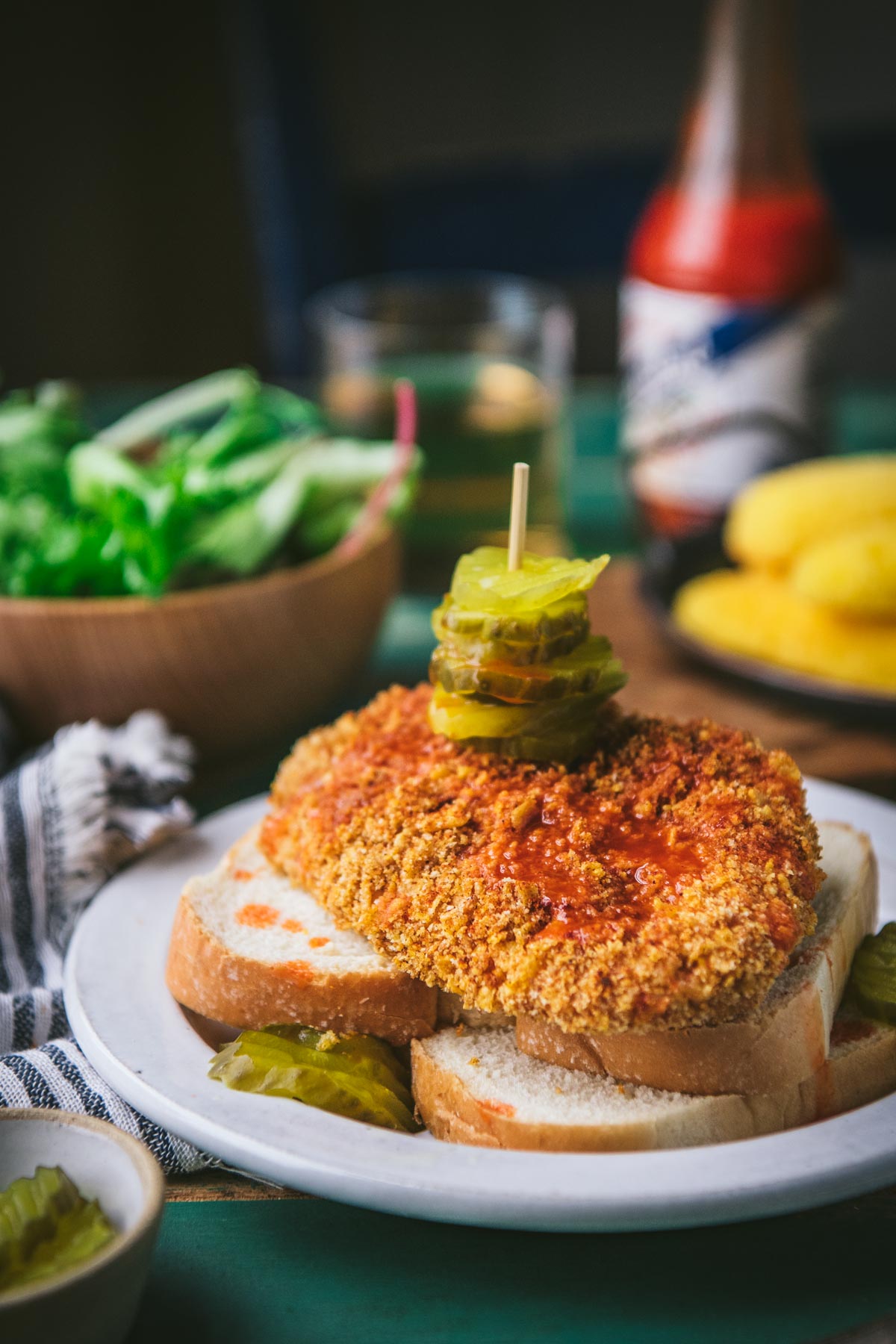 Side shot of a Nashville hot chicken sandwich on a table.