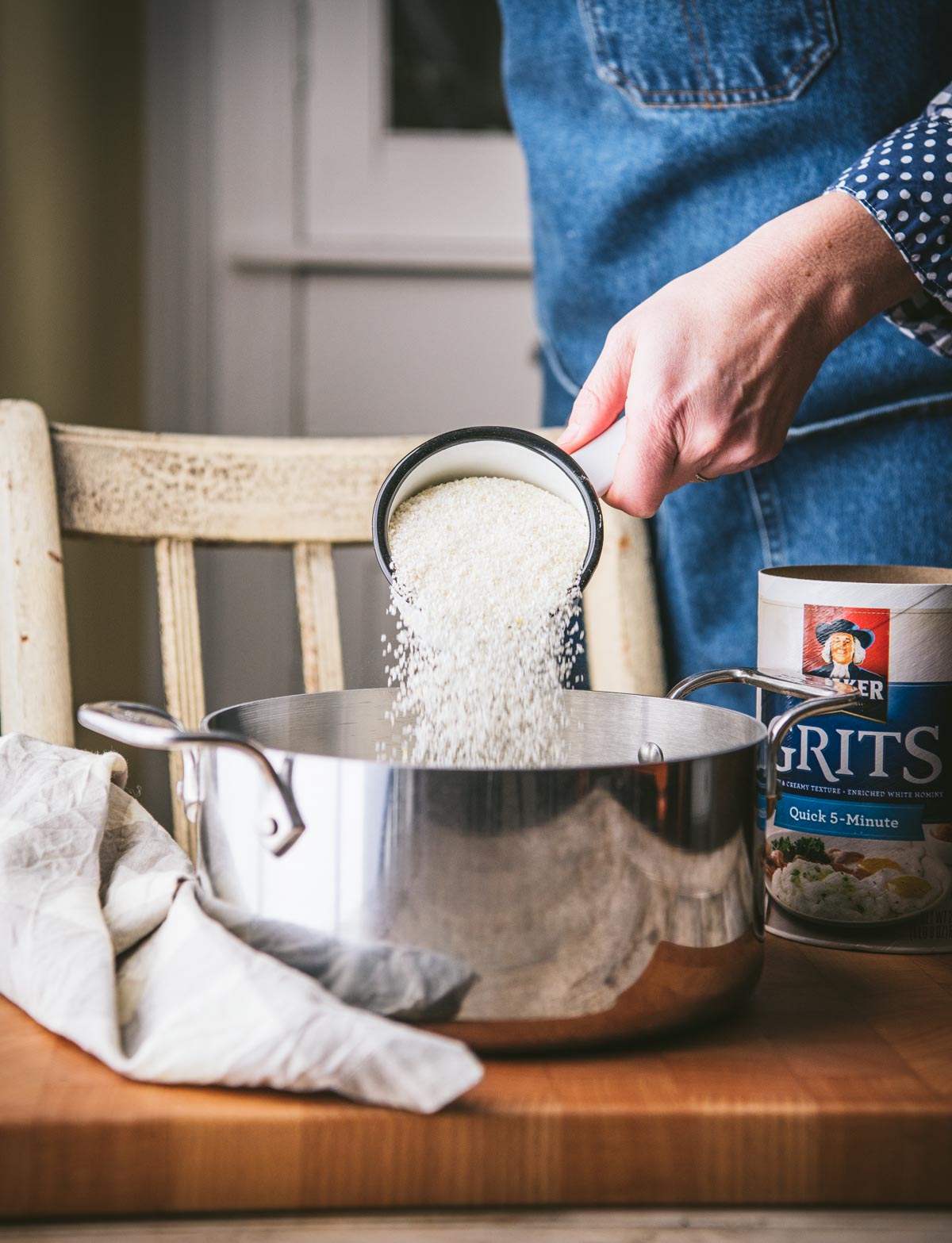 Pouring quick grits into a pot