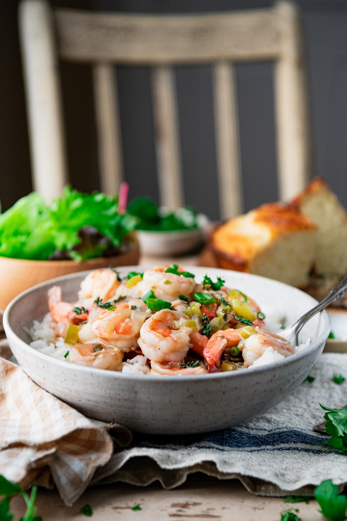 Side shot of easy shrimp etouffee in a bowl on a dinner table.