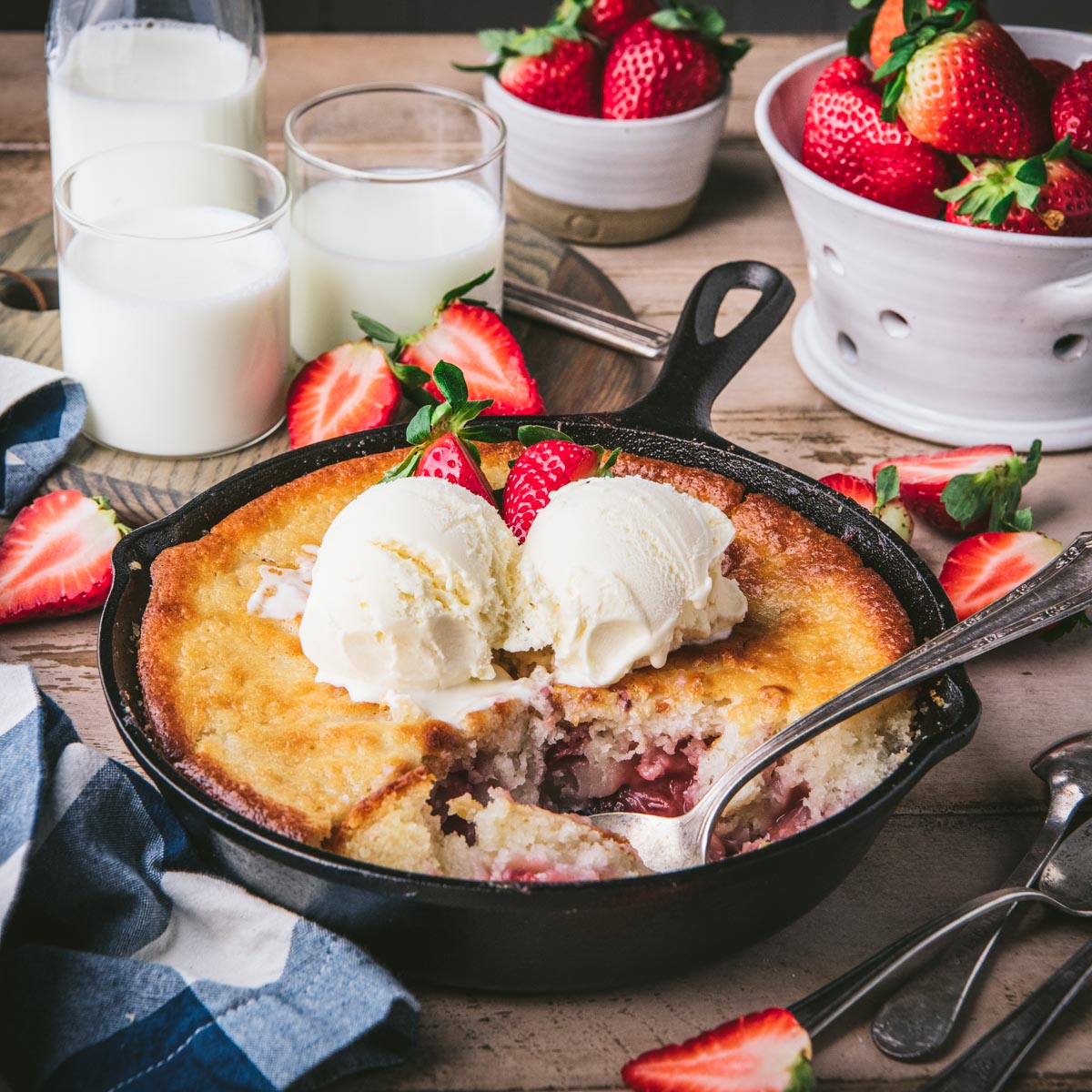 Square side shot of easy strawberry cobbler in a cast iron skillet.