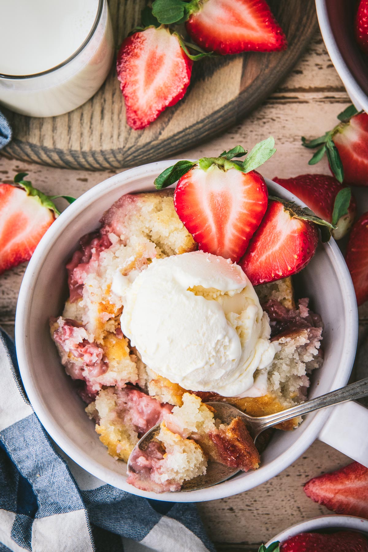 Close overhead image of a bowl of strawberry cobbler.