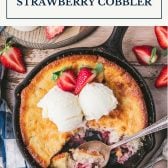 Overhead image of a pan of old fashioned strawberry cobbler with text title box at top.