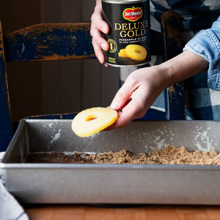 Arranging pineapple slices in the pan.