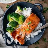 Square overhead shot of a bowl of 4 ingredient baked salmon with rice