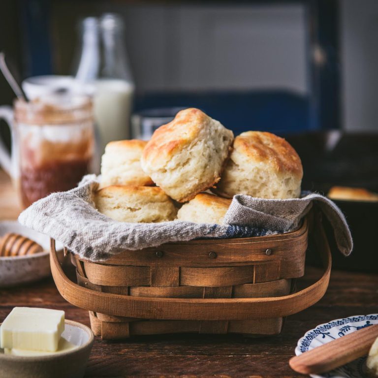 Basket of homemade angel biscuits on a breakfast table.