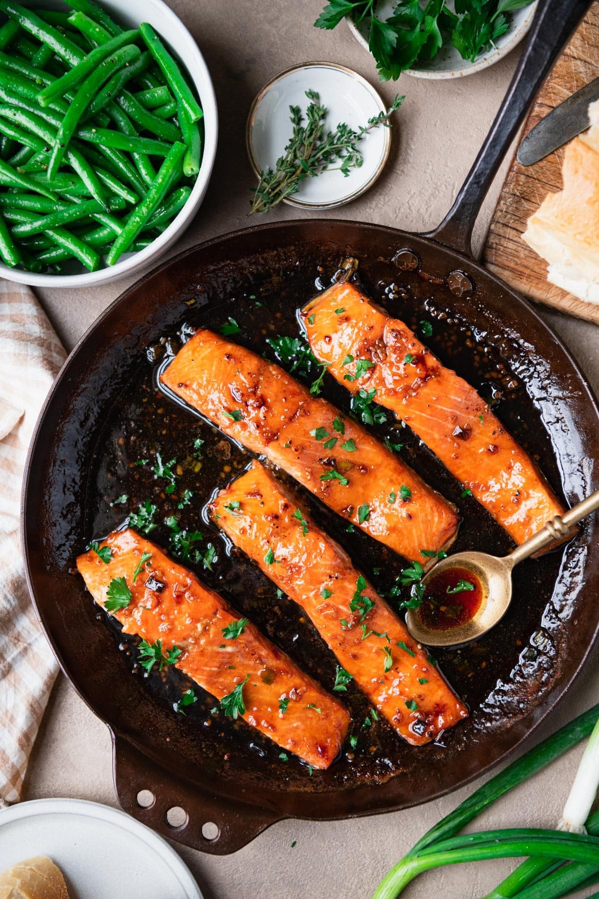 Overhead image of bourbon glazed salmon with a side of green beans and bread.