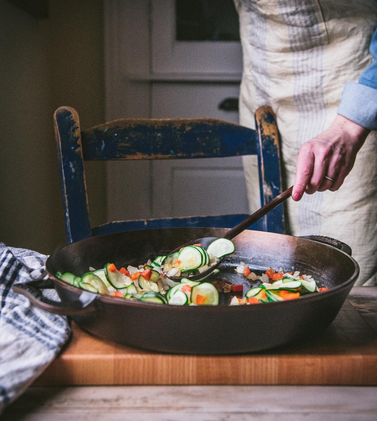 Sauteing vegetables in a cast iron skillet.