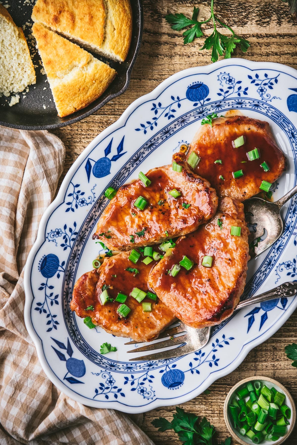 Overhead image of glazed coca cola pork chops on a blue and white platter