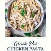 Bowl of crock pot garlic parmesan chicken pasta with text title at the bottom.