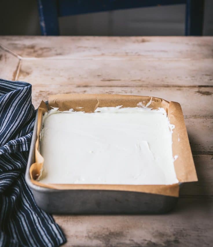 Process shot showing how to make easy lemon bars with graham cracker crust.