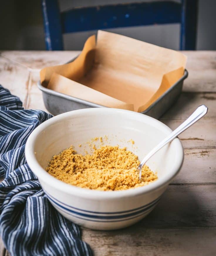 Ingredients for no bake graham cracker crust in a bowl.