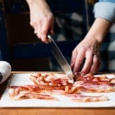 Cutting bacon strips in half.