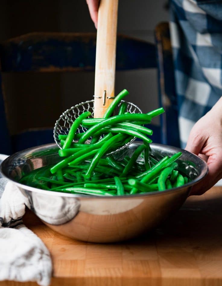 Process shot showing how to blanch fresh green beans.