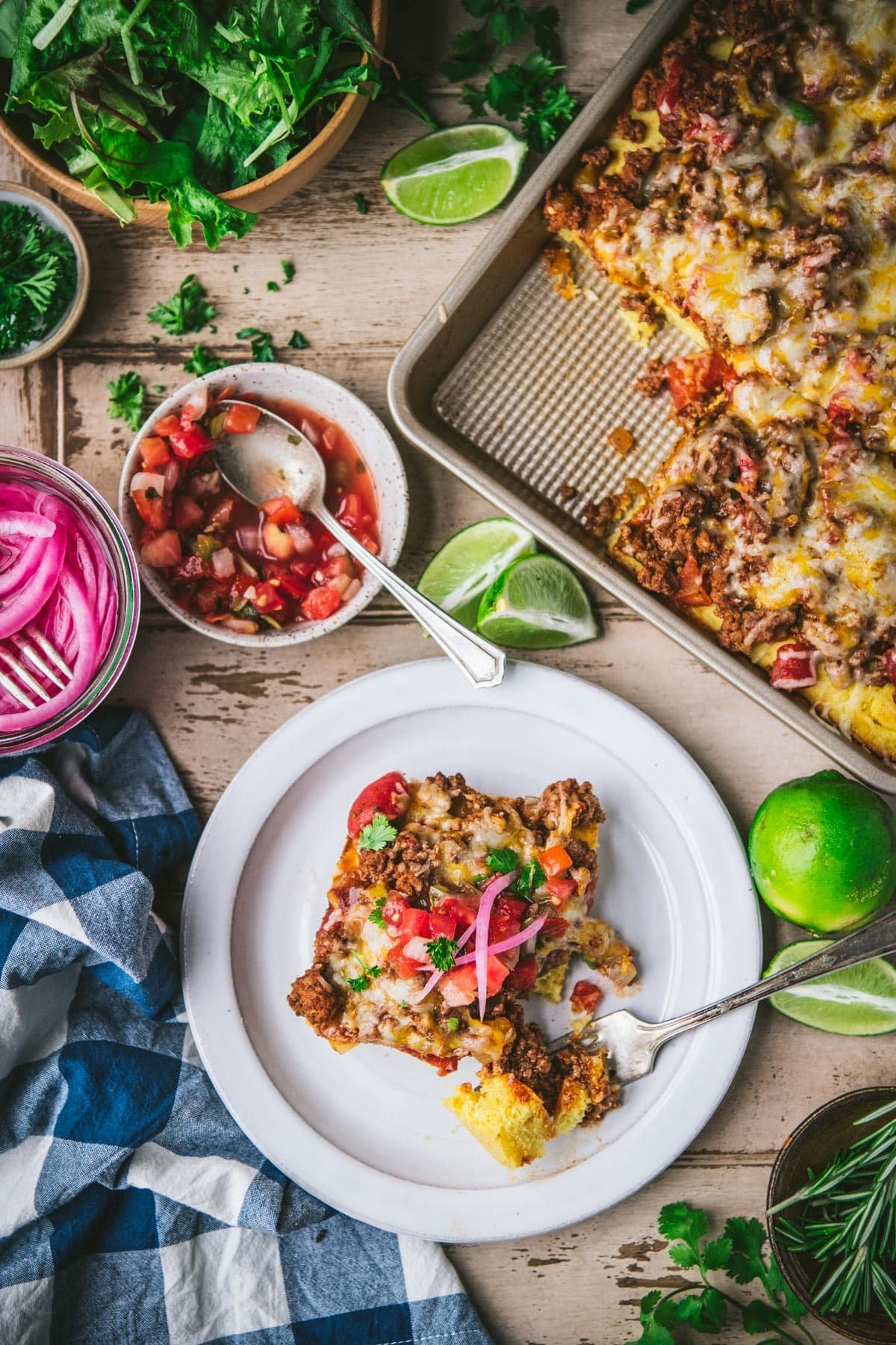 Overhead shot of homemade mexican pizza on a dinner table