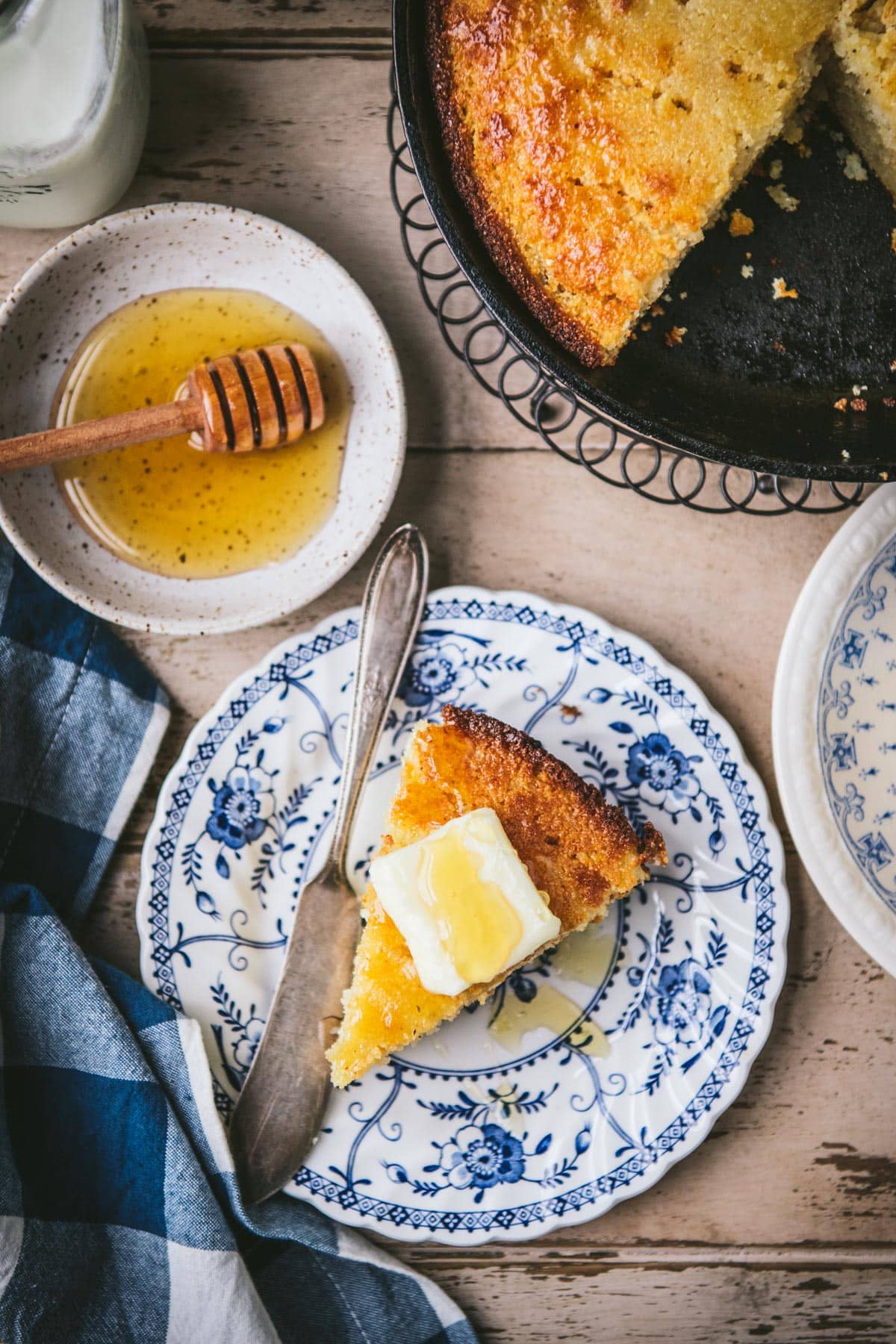 Plates of honey butter cornbread on a table.