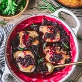 Blackberry sauce for chicken in a skillet with chicken thighs.
