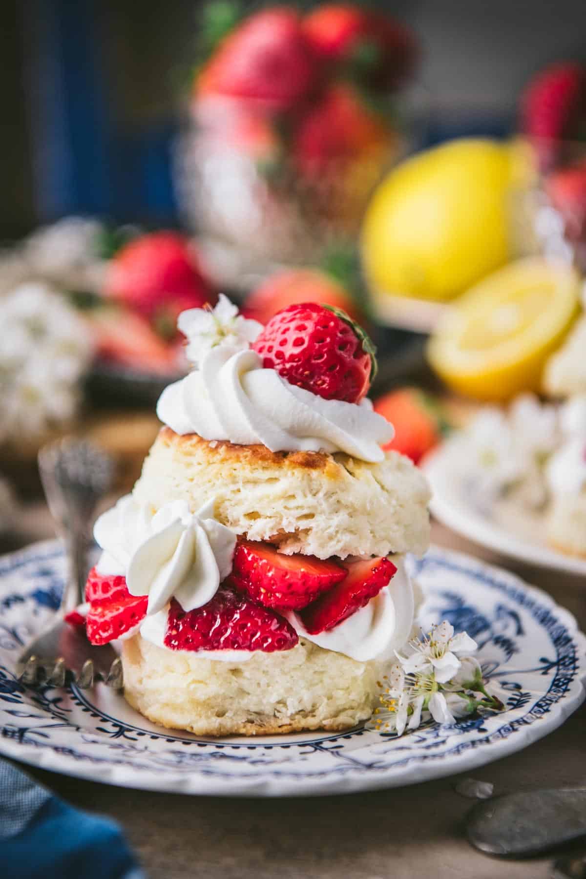 Close up side shot of strawberry shortcake biscuits on a table.