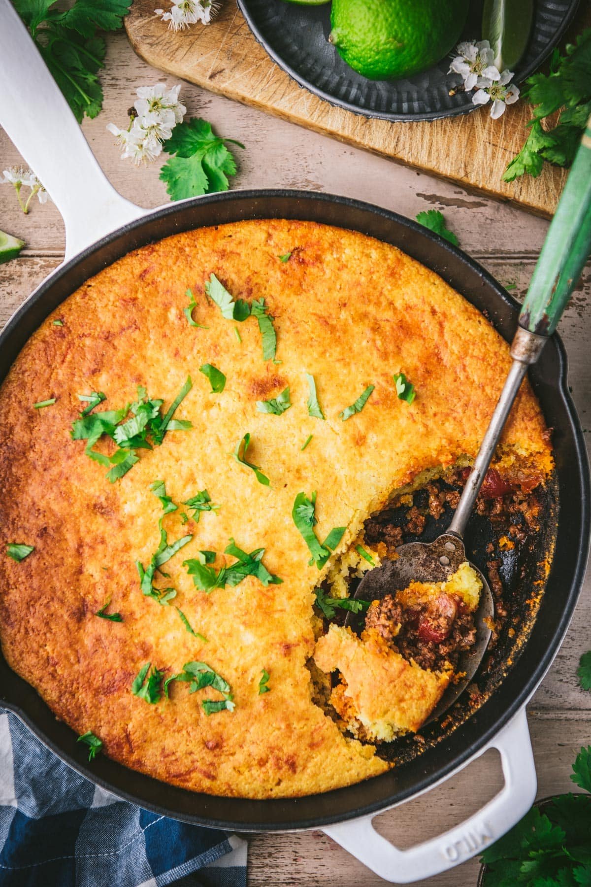 Close overhead shot of a spoon in a skillet of easy tamale pie