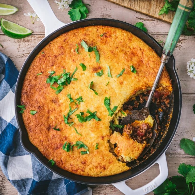 Square overhead image of a skillet of old school tamale pie recipe.