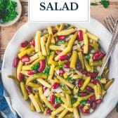 Bowl of three bean salad with text title overlay