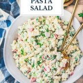 Bowl of tuna pasta salad with text title overlay.