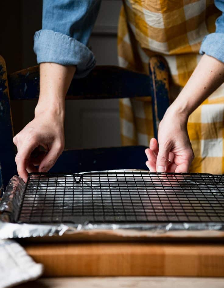 Placing a wire rack on a rimmed baking sheet.