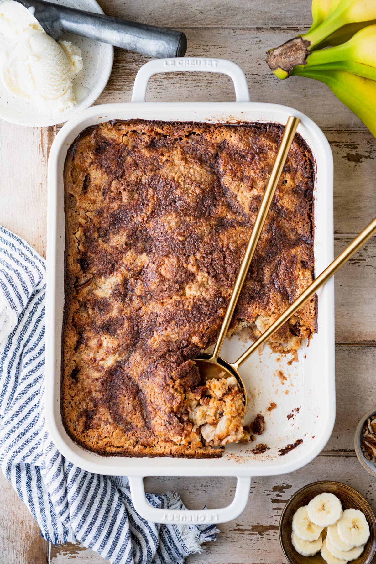 Overhead image of an easy banana dump cake recipe baked in a white dish.