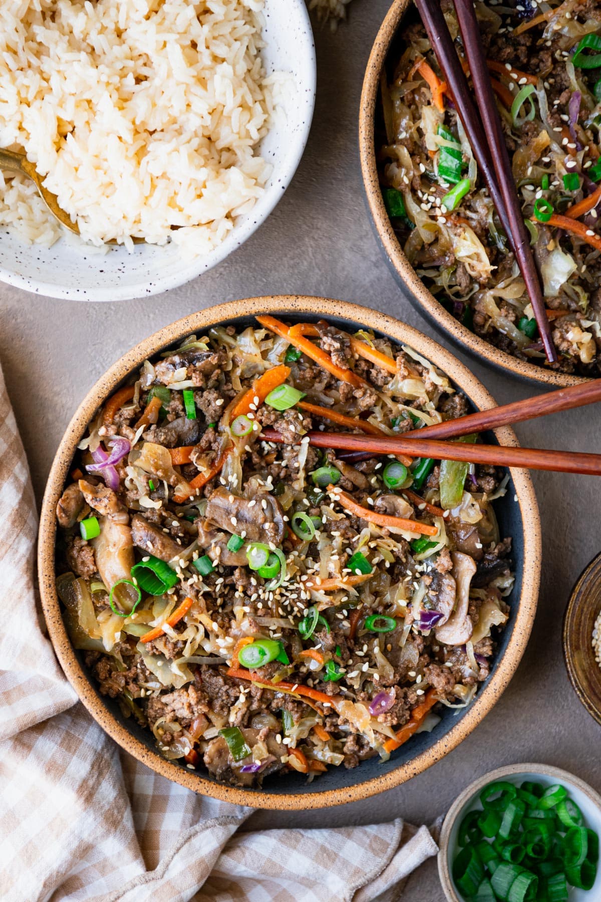 Close overhead shot of a bowl of simple ground beef stir fry with a side of rice.