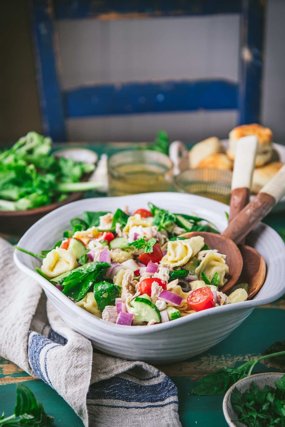 Side shot of a bowl of cold tortellini salad.