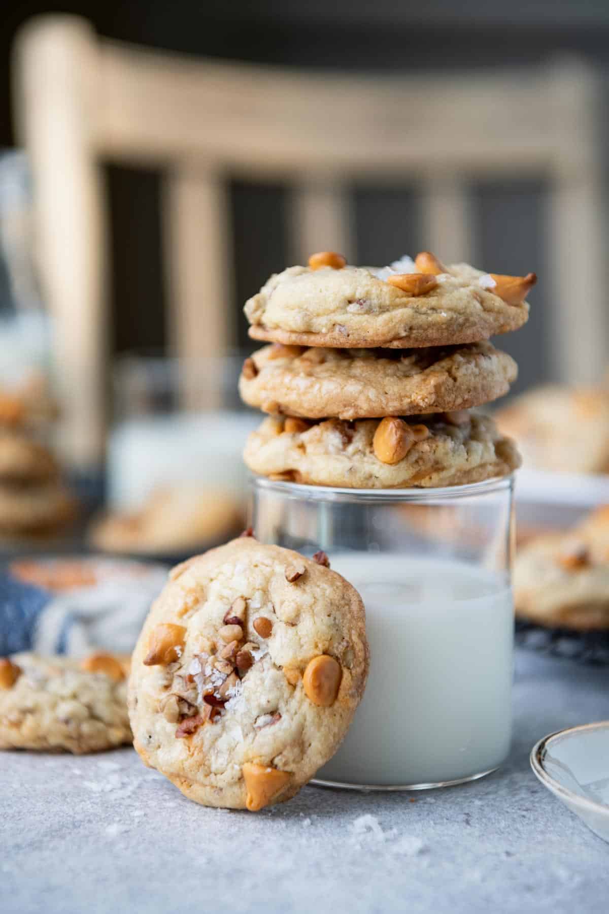 Butterscotch cookies with pecans alongside a glass of milk.