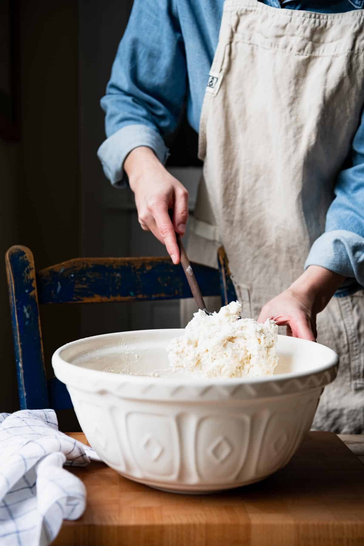 Stirring dough for cathead biscuits in a large bowl.