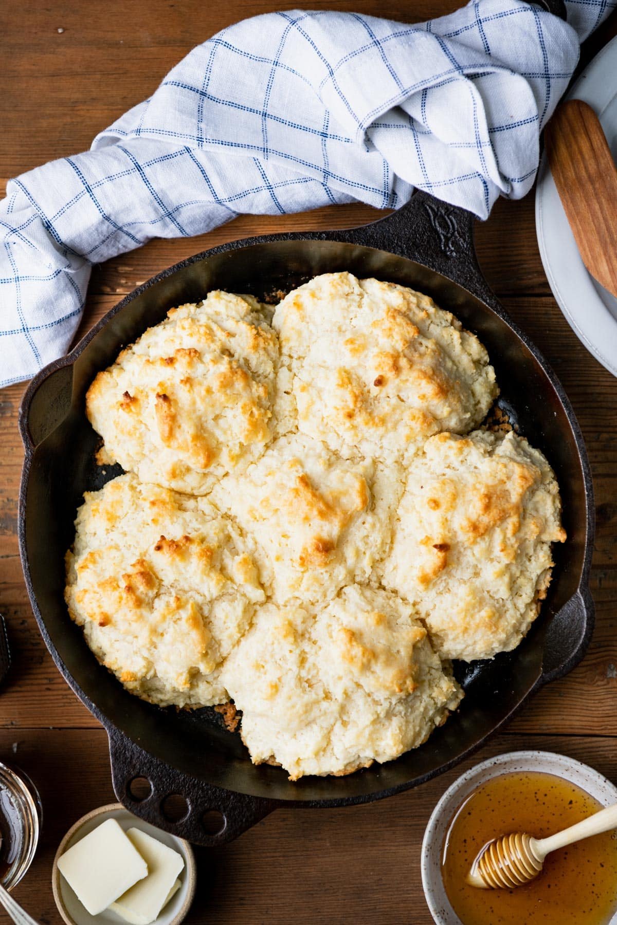 Overhead shot of cathead biscuits in a cast iron skillet.