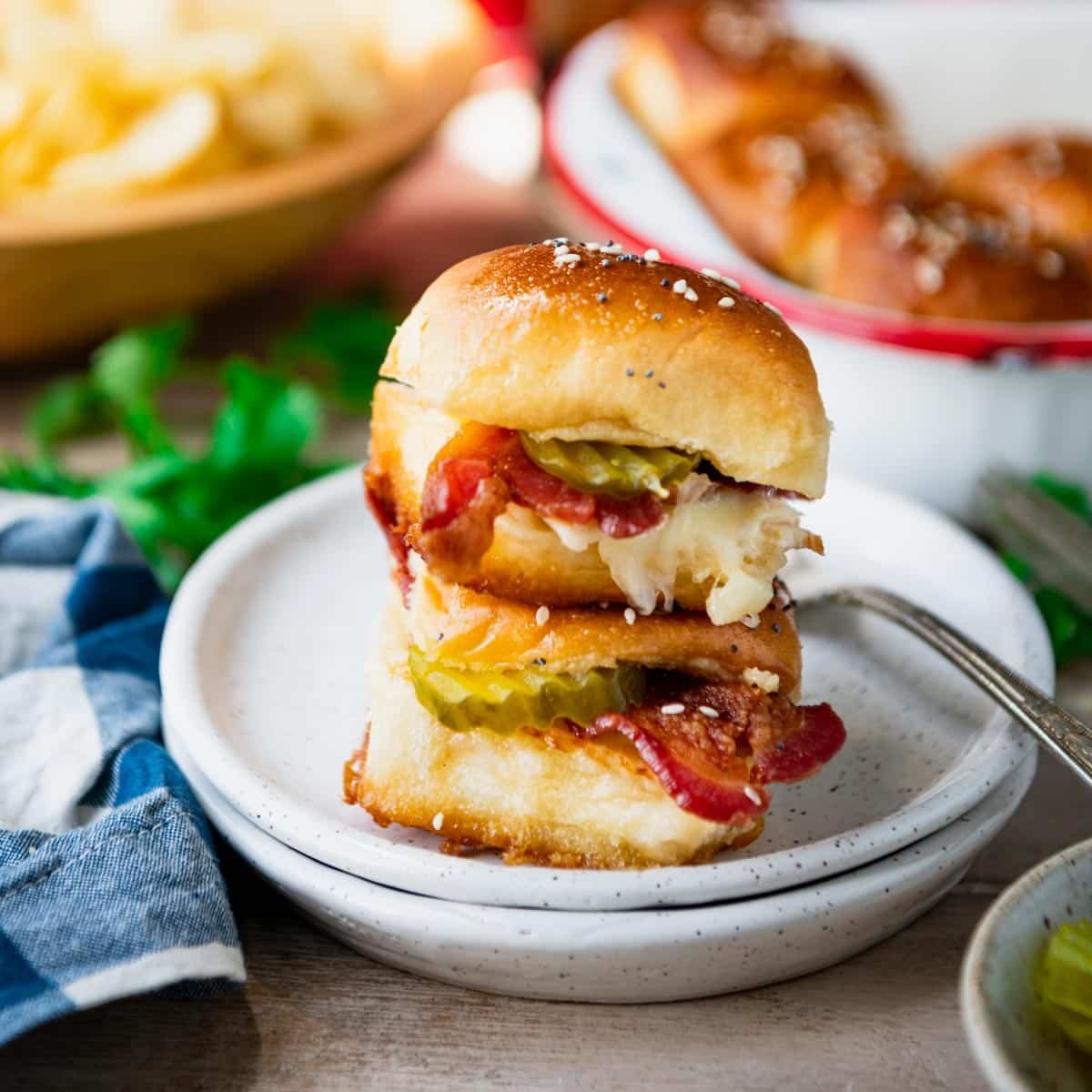 Two chicken bacon ranch sandwich sliders on a small white plate.