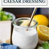 Jar of creamy caesar dressing with text title box at top.