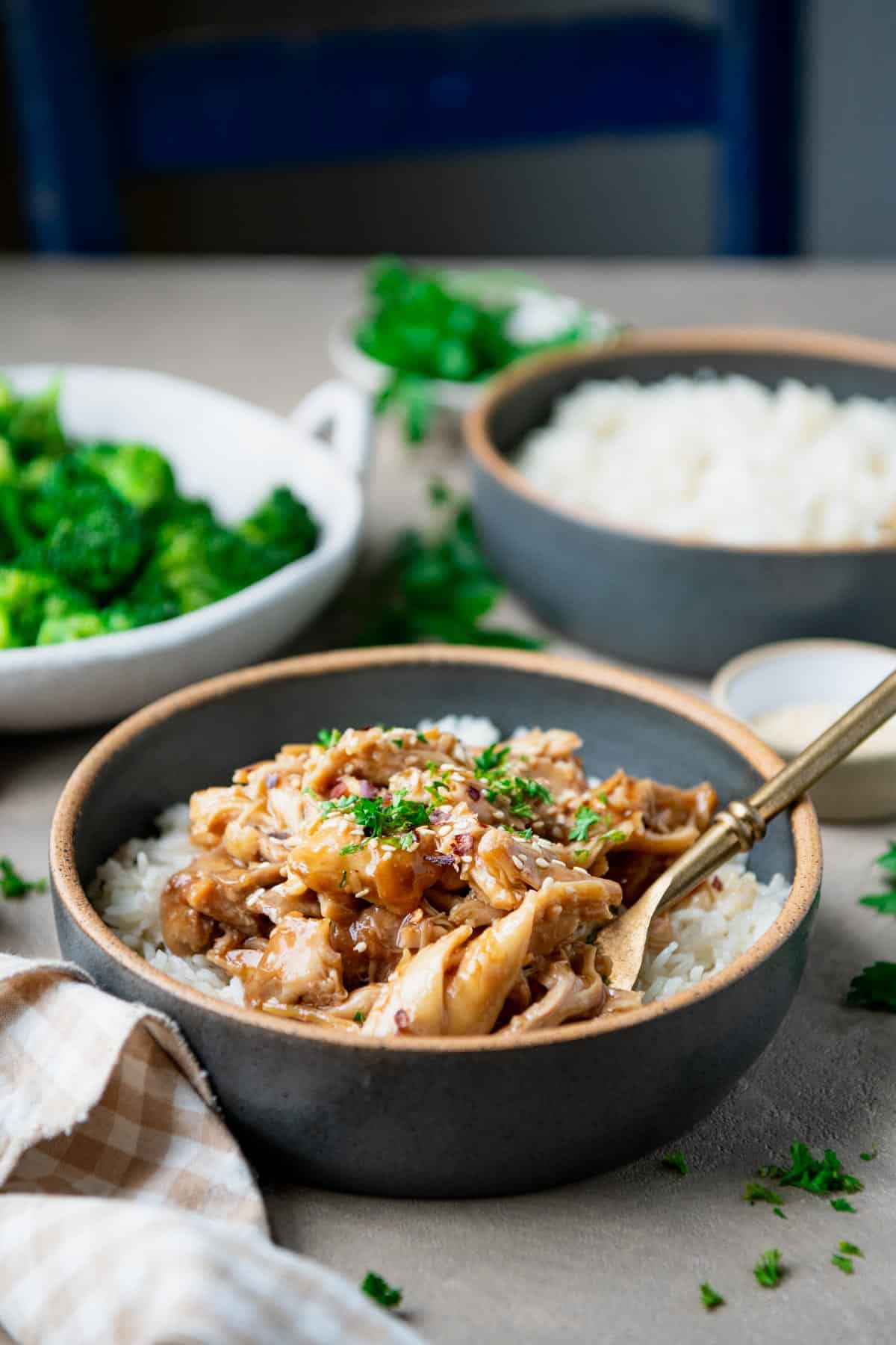 Side shot of a bowl of maple chicken over rice.