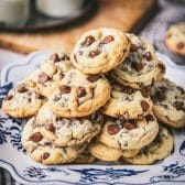 Platter of thick, soft, and chewy salted chocolate chip cookies.