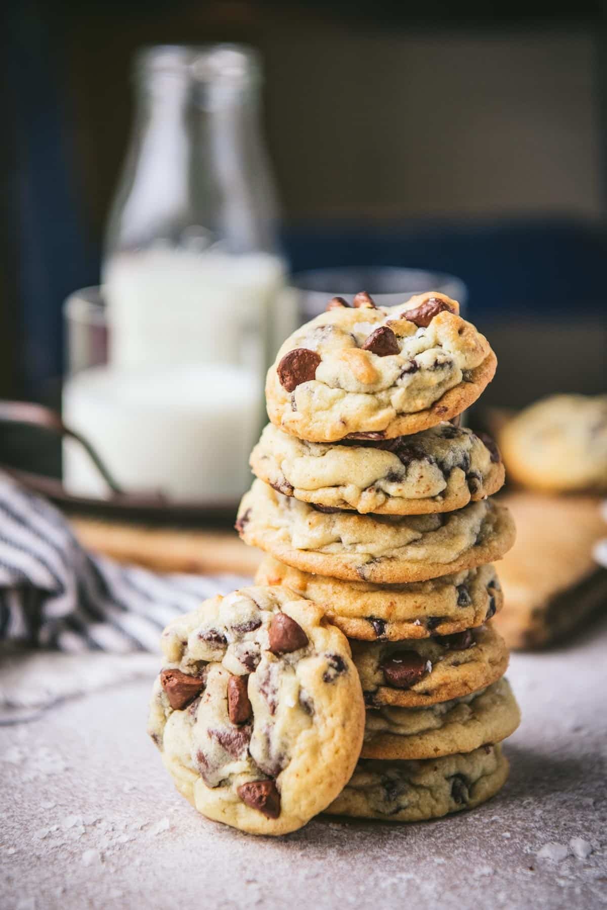 Stack of the best sea salt chocolate chip cookies recipe on a wooden table.