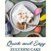 Zucchini cake on a plate with text title at the bottom.