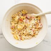 Stirring the dressing into a cornbread salad.