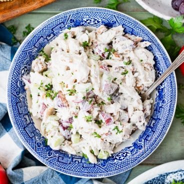 Square overhead image of Greek yogurt chicken salad in a blue and white serving bowl.