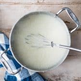 Whisking a pot of grits.